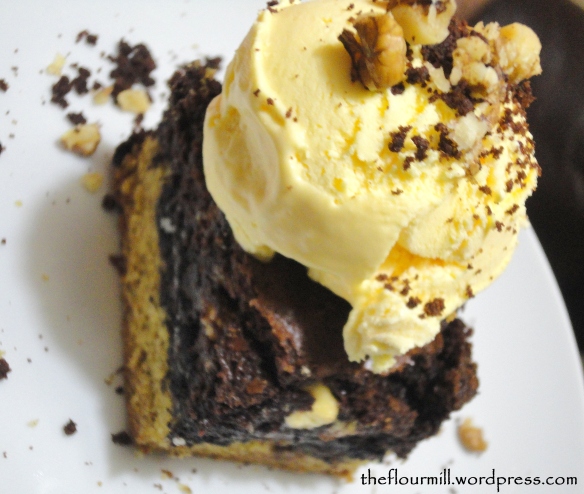 Cookie oreo fudge brownie topped with ice cream and walnuts